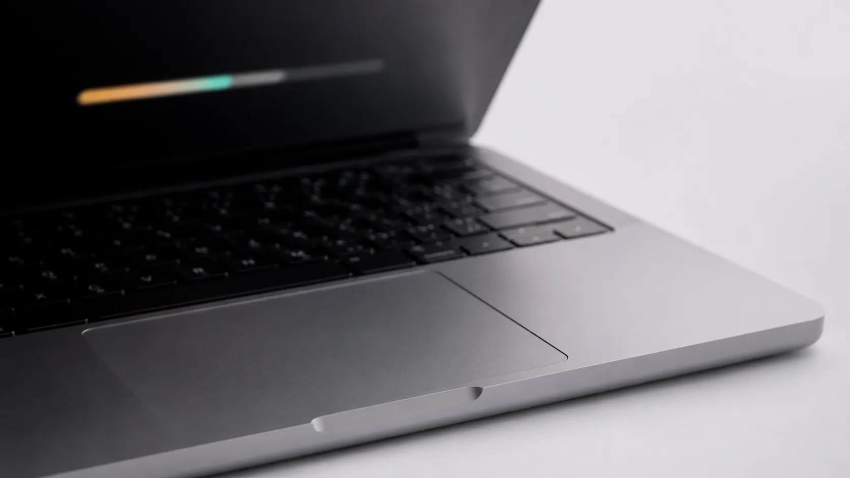 MacBook trackpad with blurred storage graphic representing the best mac cleaner storage check