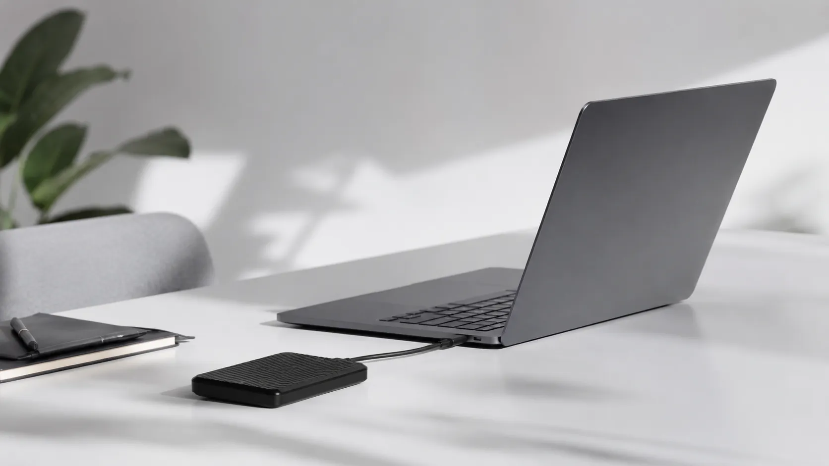 MacBook Air and external SSD on a clean desk representing the search for the best mac cleaner in 2026