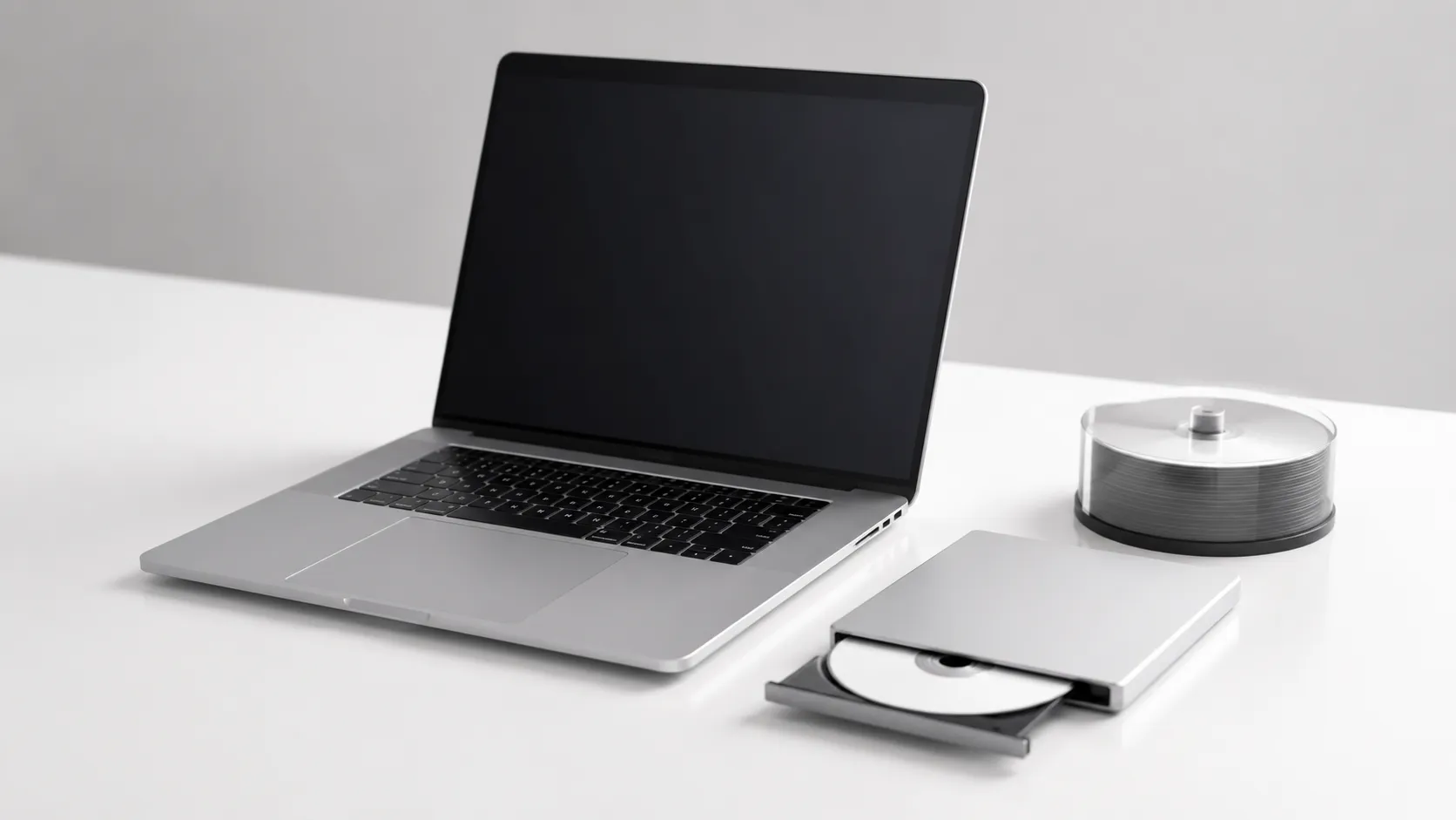 MacBook Pro with external DVD drive and blank discs set up to add subtitles and burn a DVD on Mac